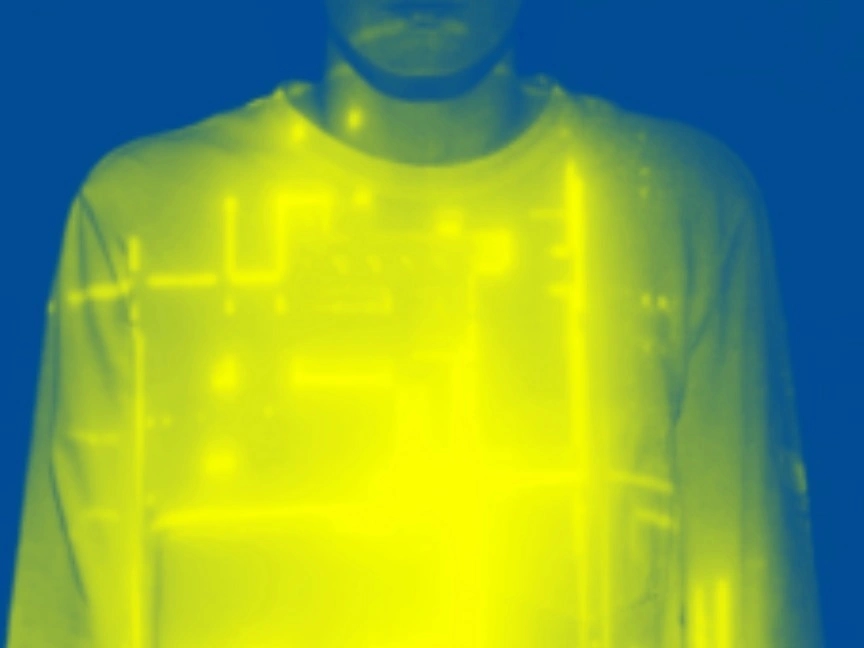 Image shows a torso wearing a long-sleeved top, with a printed circuit board superimposed on top