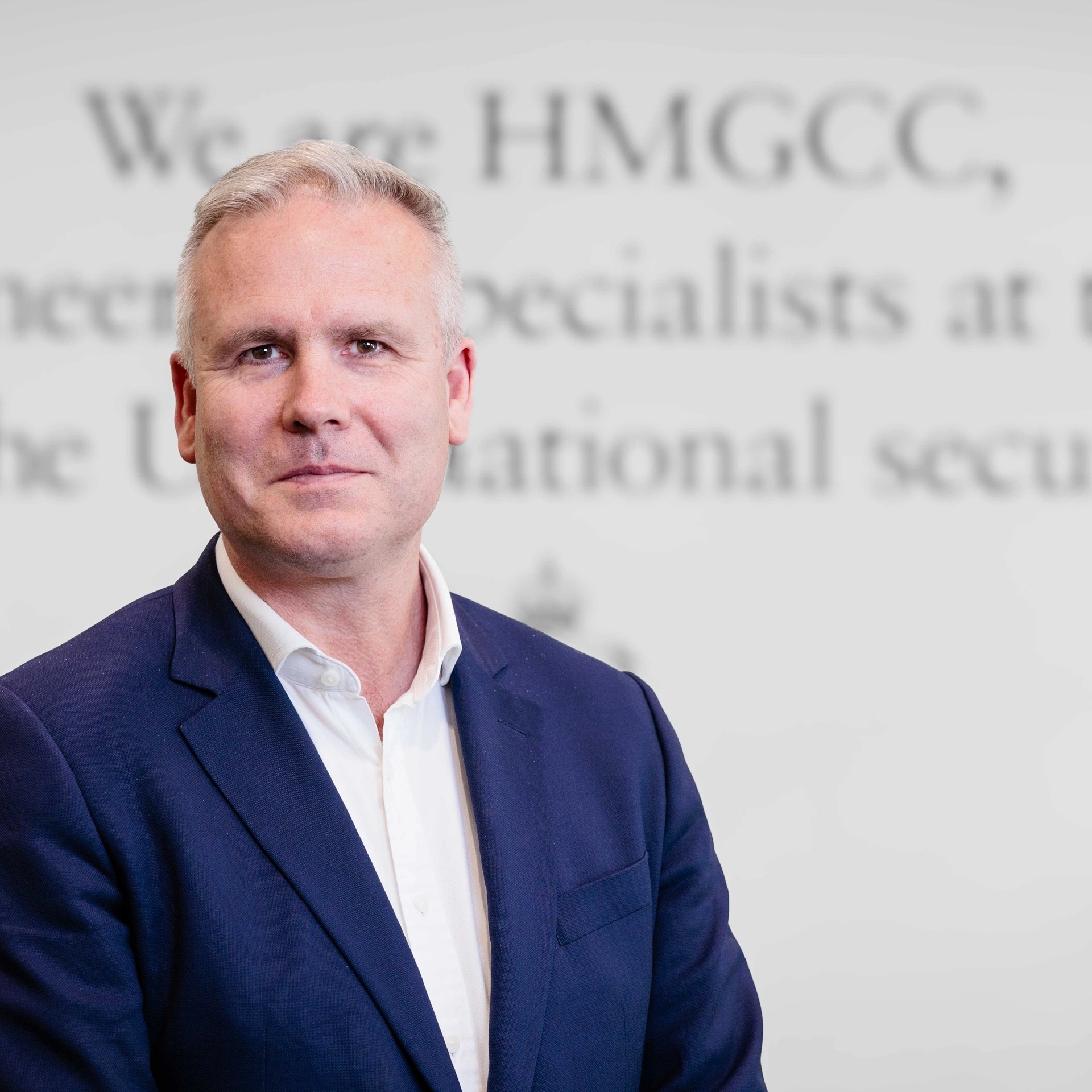 A casual headshot of our CEO, George Williamson, stood in an open neck shirt and jacket, in front of our strapline.