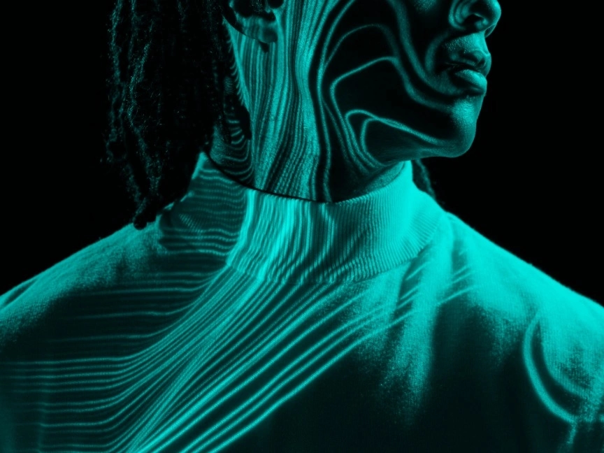 Image shows projection of circuitry on the face and upper body of a woman