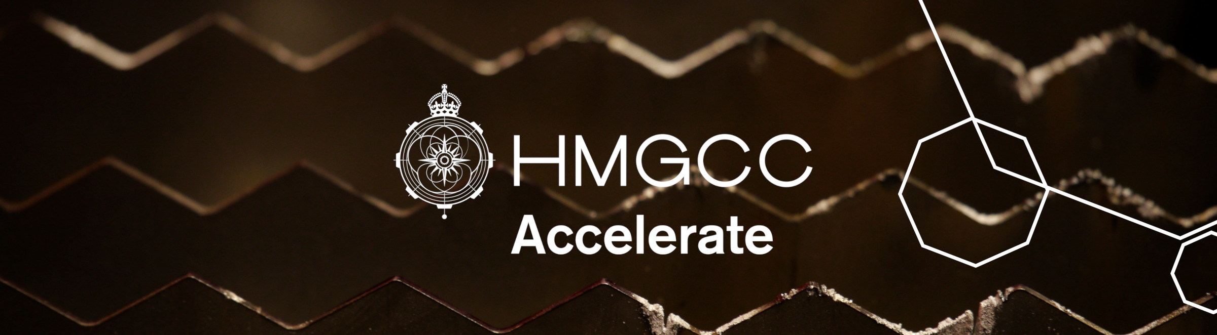 HMGCC Accelerate Logo with HMGCC Crown emblem and Octagon design elements